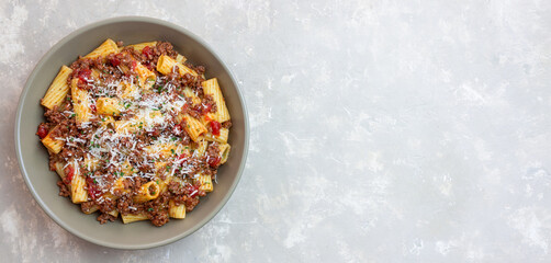 Pasta with bolognese sauce and cheese. Italian cuisine. Traditional recipe.