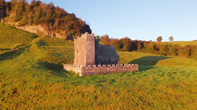 Historic stone cell at Fore Abbey, peaceful countryside in morning light