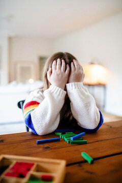 Young preteen girl covering her face with her hands frustrated