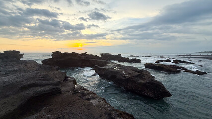 The rocks on the edge of the beach, sunset on the beach