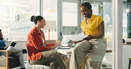 Obraz premium Women, team and documents at startup, happy and talk for review, laptop or planning at media company. People, computer and smile with report, insight or collaboration in office at creative agency