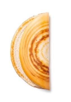 Perfectly cooked golden half-folded dosa top view isolated on white background