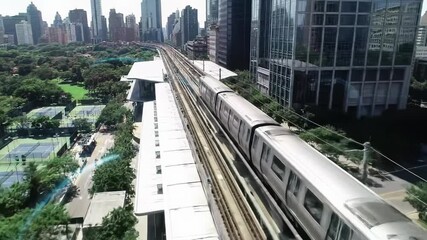 Aerial video tracks sleek elevated train gliding over a vibrant, futuristic urban landscape with glowing digital overlays, smart city infrastructure and AI concept. - Powered by Adobe