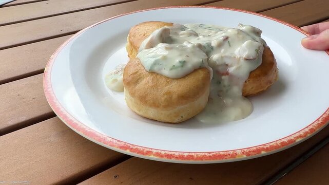Serving a Plate of Southern Sausage Gravy on Biscuits 