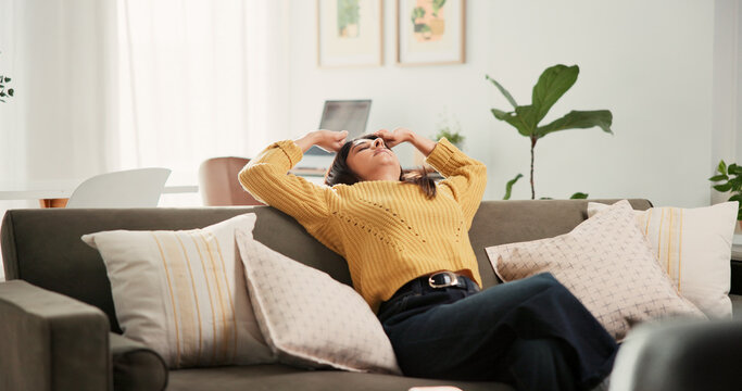 Home, stretching and woman on sofa, relax and comfortable with weekend break in living room. Apartment, stress free and happy person on couch, calm and peace with lazy afternoon, resting and day off