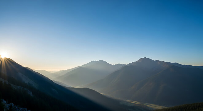 Sun shining over a mountain range with a clear blue sky and a hazy atmosphere in the distance ai generated