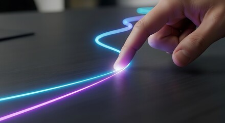 Finger tracing glowing lines on a dark surface.