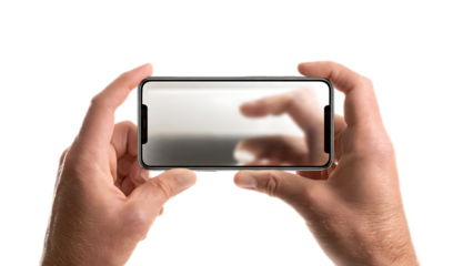 Hands holding a smartphone in landscape mode displaying a blurry image on a black background