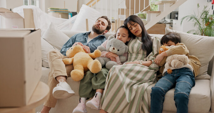 Parents, children and sleeping on sofa in new home, moving or toys with boxes, care and tired in lounge. People, family and kids with rest, exhausted and property with real estate investment in house