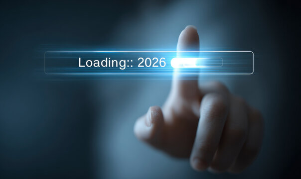 A finger touches a loading bar that says "Loading:: 2026" on a blue screen.