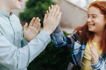 Playful redhead kids bonding on sunny stone staircase during leisure time