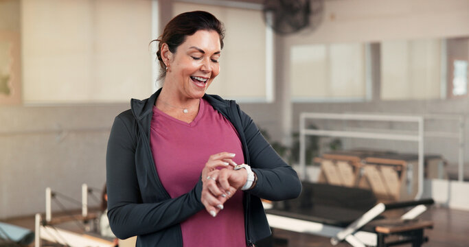 Check, smart watch and mature woman in gym, fitness and tracking workout progress on app and online. Health club, info and person with exercise goals, wellness and monitor heart rate with technology