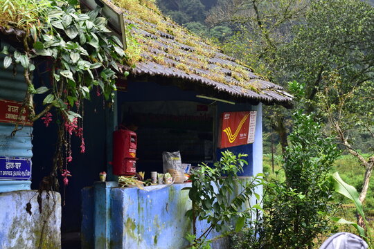 Valparai, Tamilnadu, India - September 28, 2025: A small remote hillside India Post office surrounded by lush greenery in Chinnakallar, known for its heavy rainfall and serene tea garden landscapes
