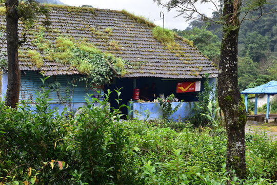 Valparai, Tamilnadu, India - September 28, 2025: A small remote hillside India Post office surrounded by lush greenery in Chinnakallar, known for its heavy rainfall and serene tea garden landscapes
