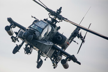Military Apache Helicopter Flying at Low Altitude