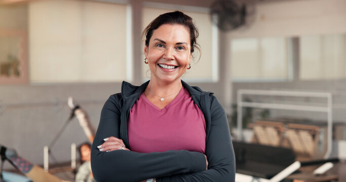 Portrait, woman and instructor with arms crossed for pilates, fitness and session. Happy, female person and personal trainer for exercise course, training support and join us for wellness membership - Powered by Adobe