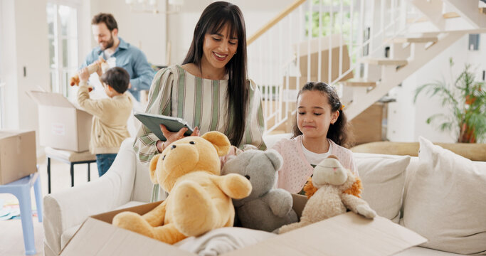 Mom, girl and tablet with boxes in new home with toys, smile and checklist for moving with real estate. People, mother and daughter on tech, app or happy for unboxing with teddy bear at family house