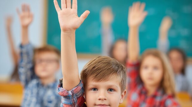 Group of diverse school children raising hands during interactive classroom lesson session