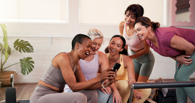 Happy, team and women with smartphone in gym, fitness and checkup workout progress on web or online. Scroll, mobile and people with technology for exercise goals, wellness and positive health results - Powered by Adobe