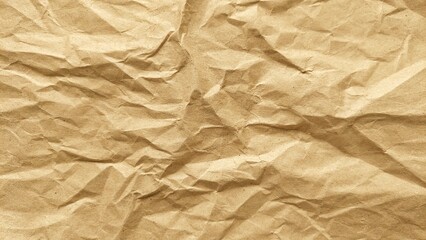 Crumpled rough brown kraft paper background with natural folds and wrinkles. Old vintage paper surface texture for design or background.