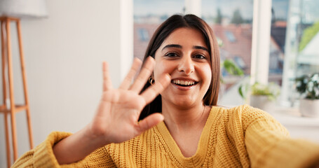 Portrait, video call and woman with happy, wave and greeting with communication POV in lounge. Live streaming, house and person with internet, hello and digital app for online chatting and talking