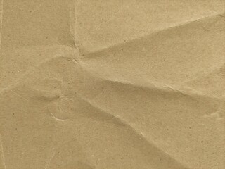 Recycled brown paper crumpled texture background. Abstract wrinkled and folded craft paper surface. Crumpled brown recycle paper background with copy space for text.