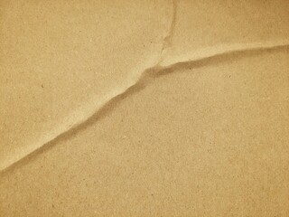 Crumpled kraft paper texture background in brown color with copy space. Old vintage paper surface for background or creative design.