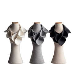 Three mannequins displaying fabric leaf-patterned collars