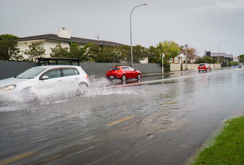 Car driving through floodwater after heavy rain. Auckland. New Zealand.