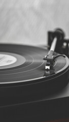 Close-up of a vintage vinyl record spinning on a turntable, with the tonearm and stylus engaged, evoking a sense of nostalgia for analog music and retro audio technology.