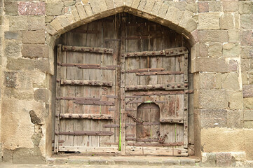 Wooden classic door at Daulatabad Fort is an ancient fort located in Maharashtra, India. Originally named Deogiri, it is a fort built from natural rocks and is very strong.