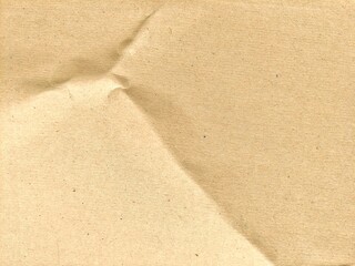 Crumpled kraft recycled brown paper texture background with copy space for design. Abstract folded and creased paper background.