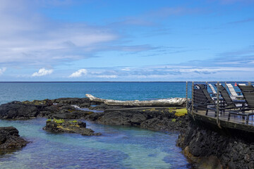 Rocky tidal pool beside wooden platform on tropical coast