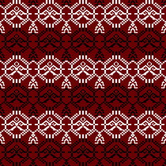 A vibrant, repeating pattern featuring intricate designs in white and black against a deep red background.