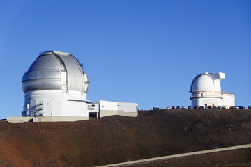 Fototapeta premium Cluster of observatory domes scattered along volcanic mountain ridge