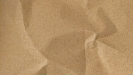 Crumpled recycled brown paper texture background. Abstract creased and wrinkled eco paper surface. Crumpled brown recycle paper background with copy space for text.