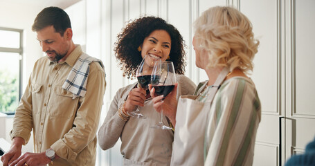 Women, family and cheers with alcohol for cooking, reunion celebration and bonding together. Happy, senior mother and people toast with red wine, meal preparation and thanksgiving gathering at house