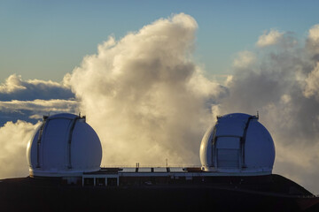Twin telescope domes floating above dramatic evening clouds © SILI