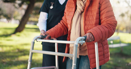 Outdoor, caregiver and old person with walker, hands and support for rehabilitation, help and...