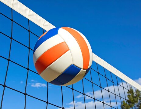 Volleyball soaring over the net against a clear blue sky.