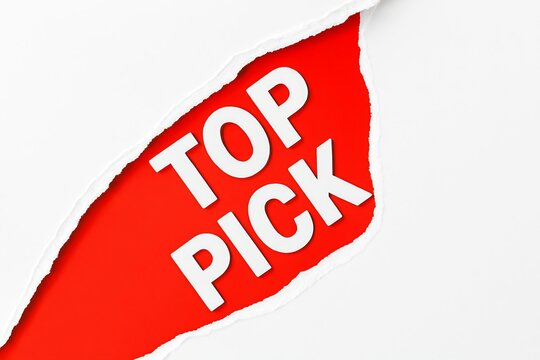 Bright red torn paper label with white text reading top pick highlighting a selection or recommendation