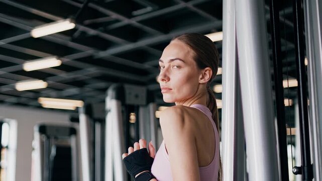 Woman workout in gym training. Fitness exercise shot shows athletic posture. Image communicates strength health wellness. Use for fitness marketing content. Ideal for gym promo and wellness campaigns.