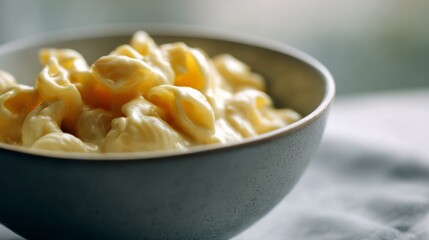 Creamy macaroni swirls in rustic bowl, ideal for comfort food indulgence, evocative of National Cheese Lover's Day warmth