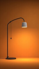 A dark metal modern floor lamp with a textured grey cylindrical shade is lit up creating a warm glow against a smooth orange gradient background. The lamp has a curved neck and a pull chain.