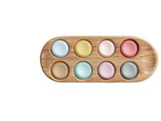 Pastel circles arranged in wood tray, black backdrop