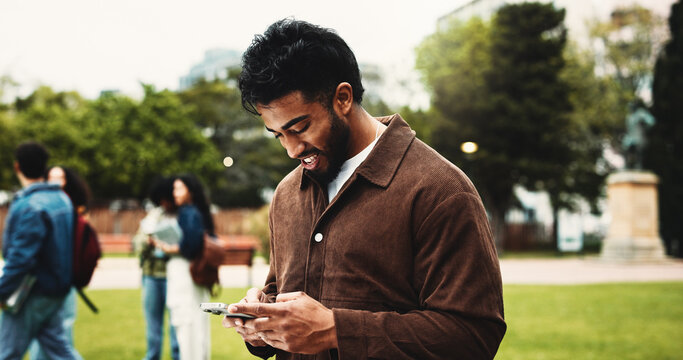 College, happy and man with phone for social media, networking and online message on campus. University, academy and student typing on smartphone for connection, internet or website outdoor at school