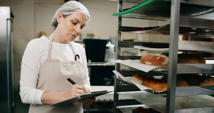 Restaurant, pastry chef and woman in commercial kitchen with checklist, document and bread. Baker person, paperwork and stock for catering, bakery industry and production for breakfast or snack