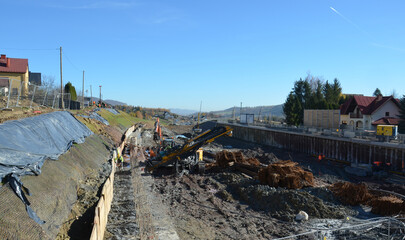 Installation of ground anchors on a mountain slope – slope stabilization and reinforcement works during railway line construction. Visible drilling rigs, steel anchors lk104. © Simonahelga