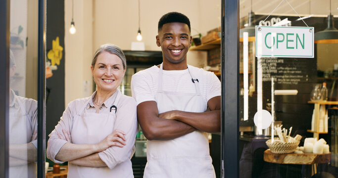 Happy people, portrait and door with open sign in cafe entrance or ready for service. Man, woman or arms crossed with confidence, apron or smile for coffee shop, small business or restaurant startup