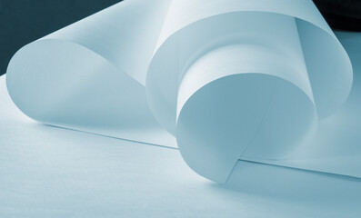 Long sheets of paper from a roll of blue tone.